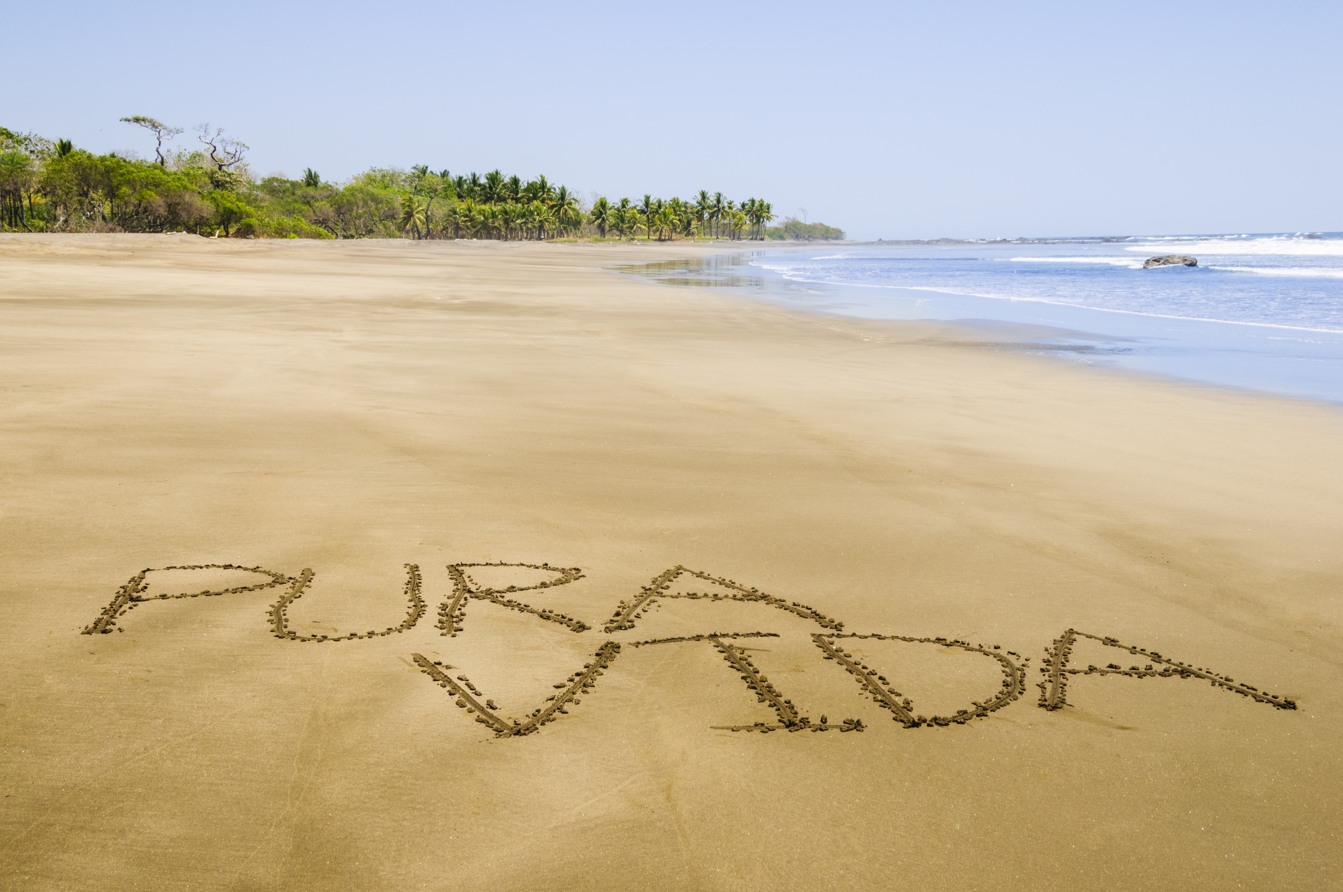 The words Pura Vida are written in sand on Cocos beach in Guanacaste province Costa Rica.