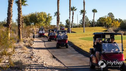Players Driving Golf Carts at The Electric Drive Golf Tournament