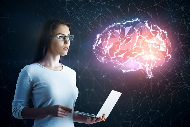 Woman holding a laptop, examining a digital brain model.