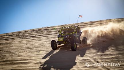 Marc Burnett in Monster Energy UTV on side of dune