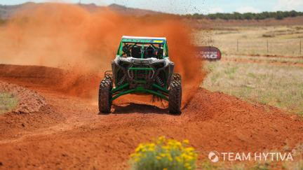 Polaris RZR Charging Around Dirt Turn